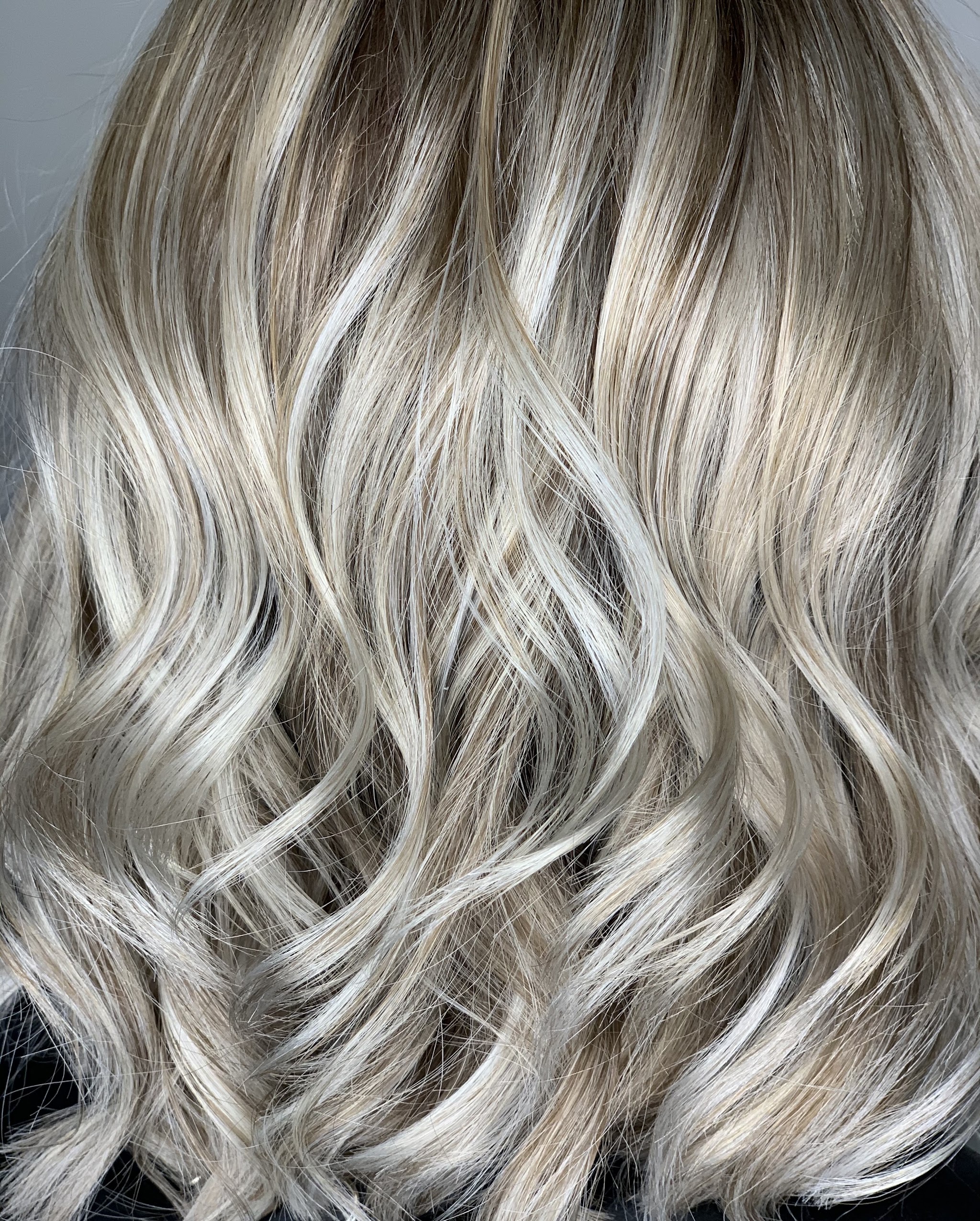 Close-up of soft ash blonde waves after styling